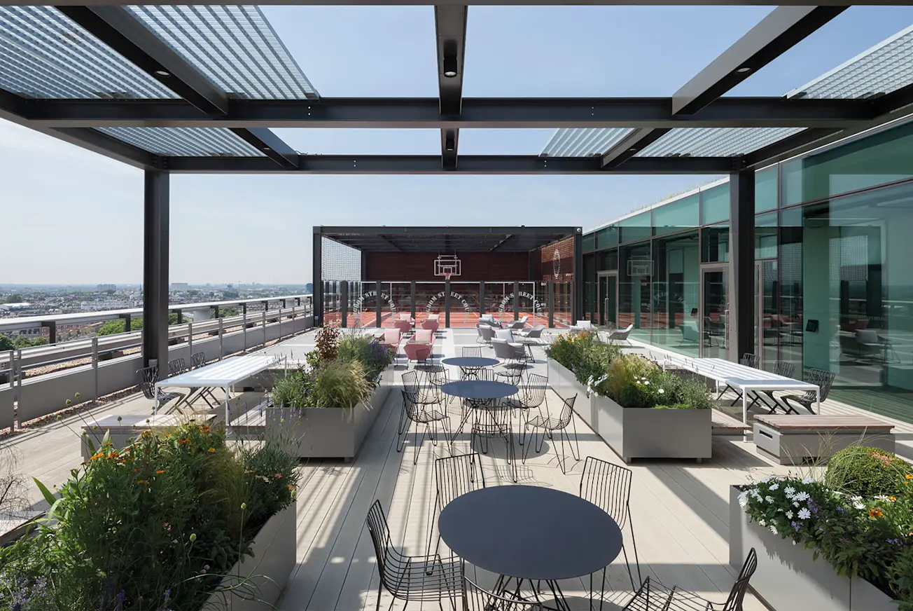 The rooftop at HL's London office, including a basketball court, with tables and chairs