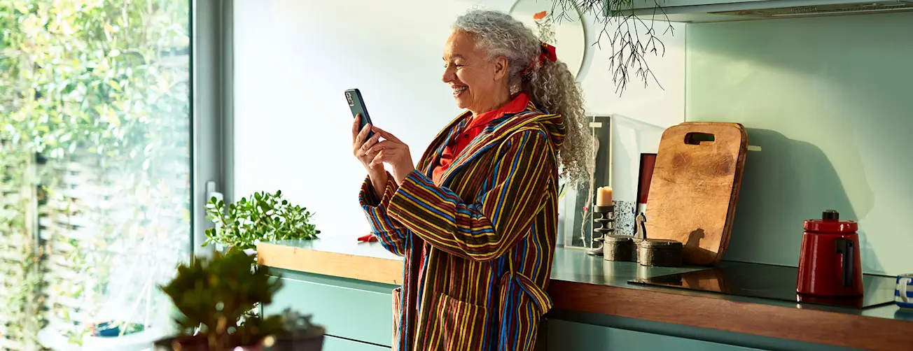 Lady stood up smiling at phone
