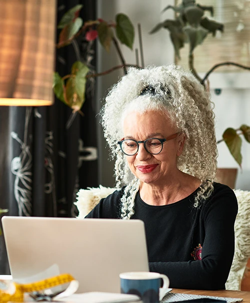 Elderly woman looking at laptop screen