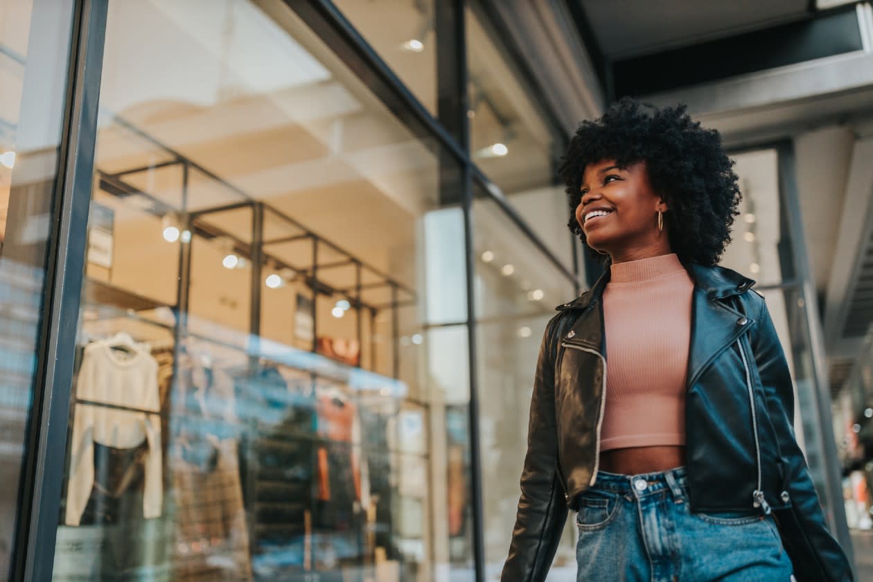 Next - young shopper walks through a shopping centre.jpg