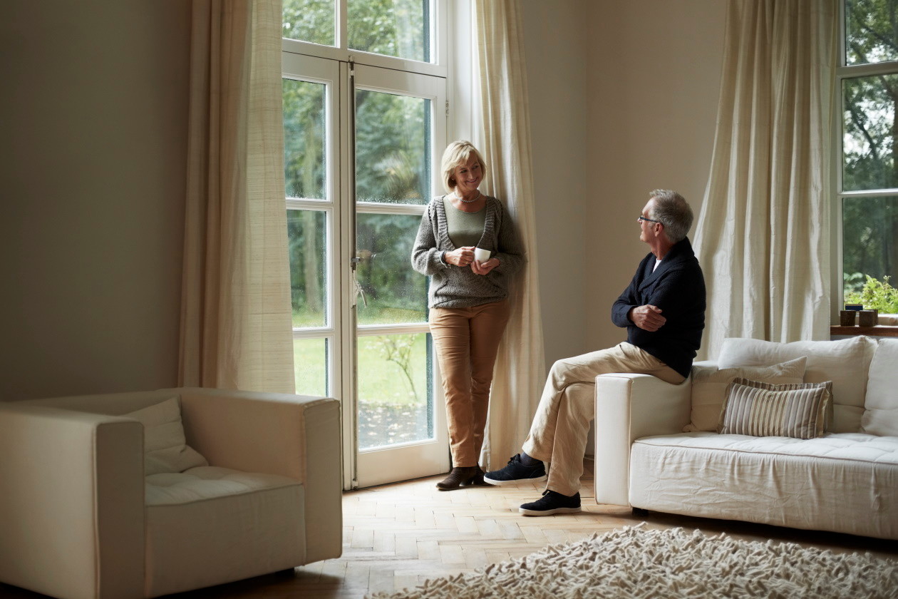 Senior couple looking at each other in stylish living room.jpg