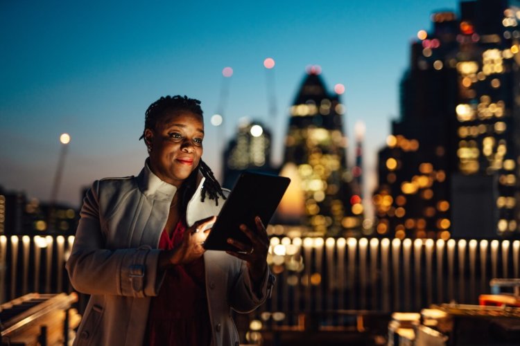 Woman on ipad with cityscape background.jpg