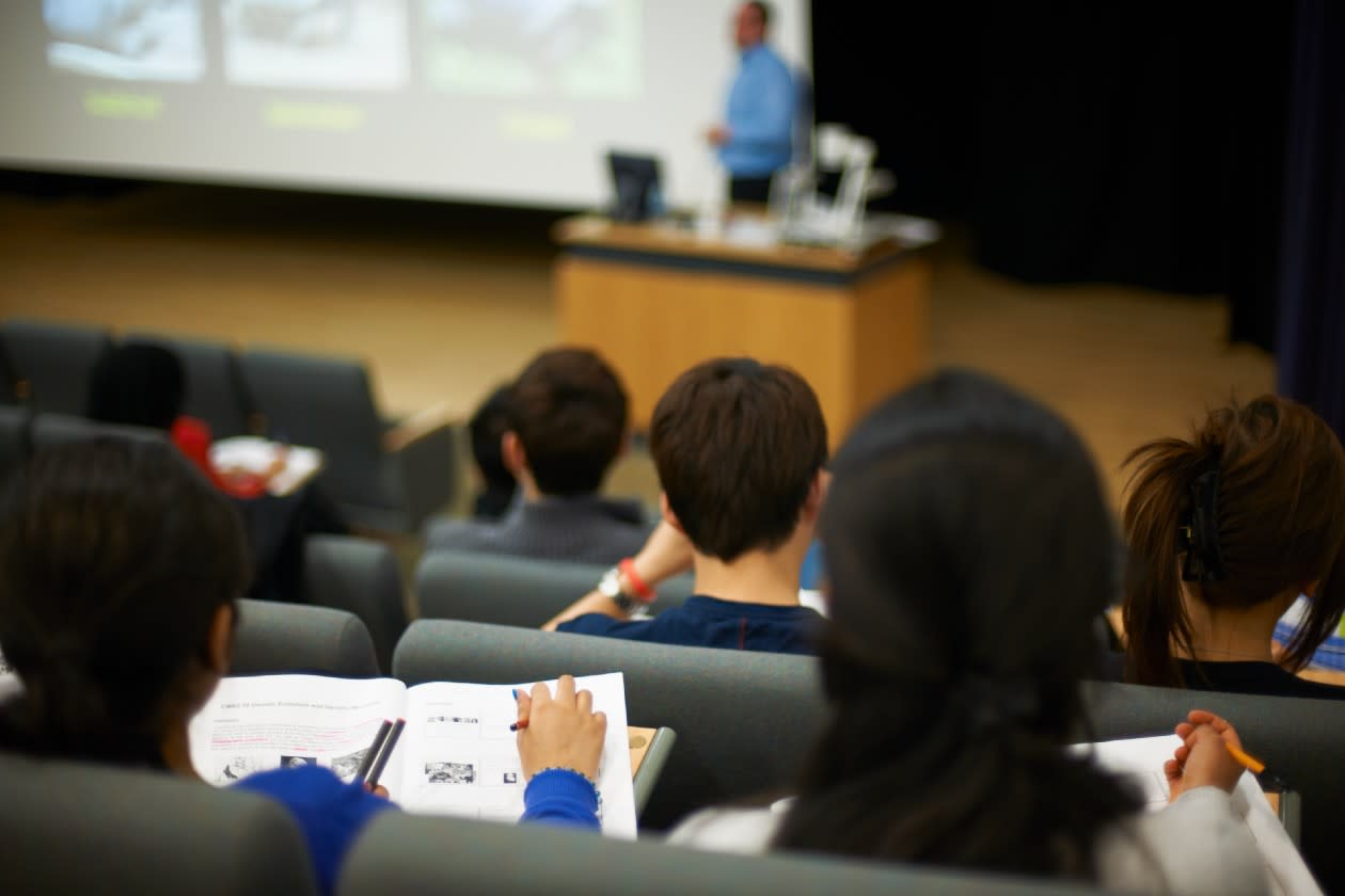 Students in a lecture theatre listening to a lecturer.jpg