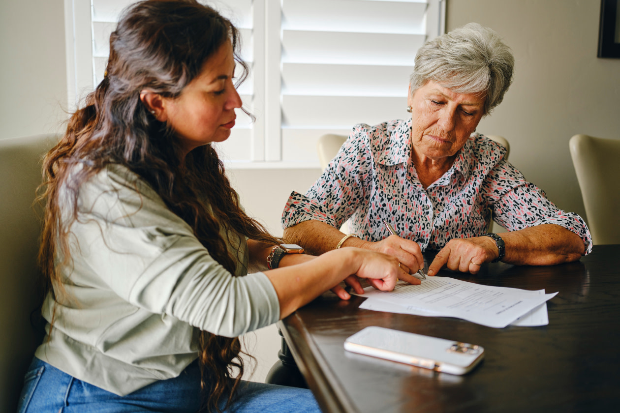 Woman helping a Senior with documents.jpg