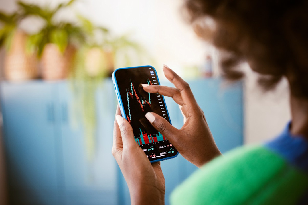 Female investor reviewing a performance chart on her phone.jpg