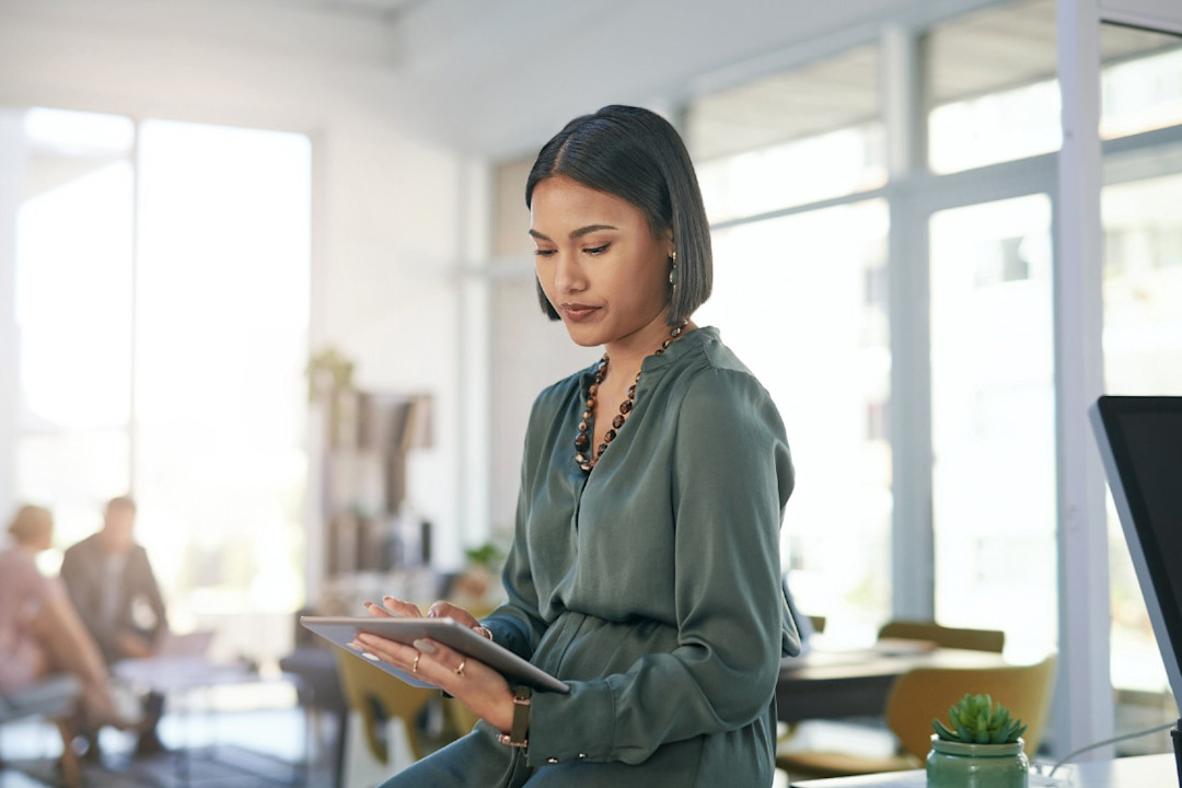 A young businesswoman using a digital tablet in a modern office.jpg