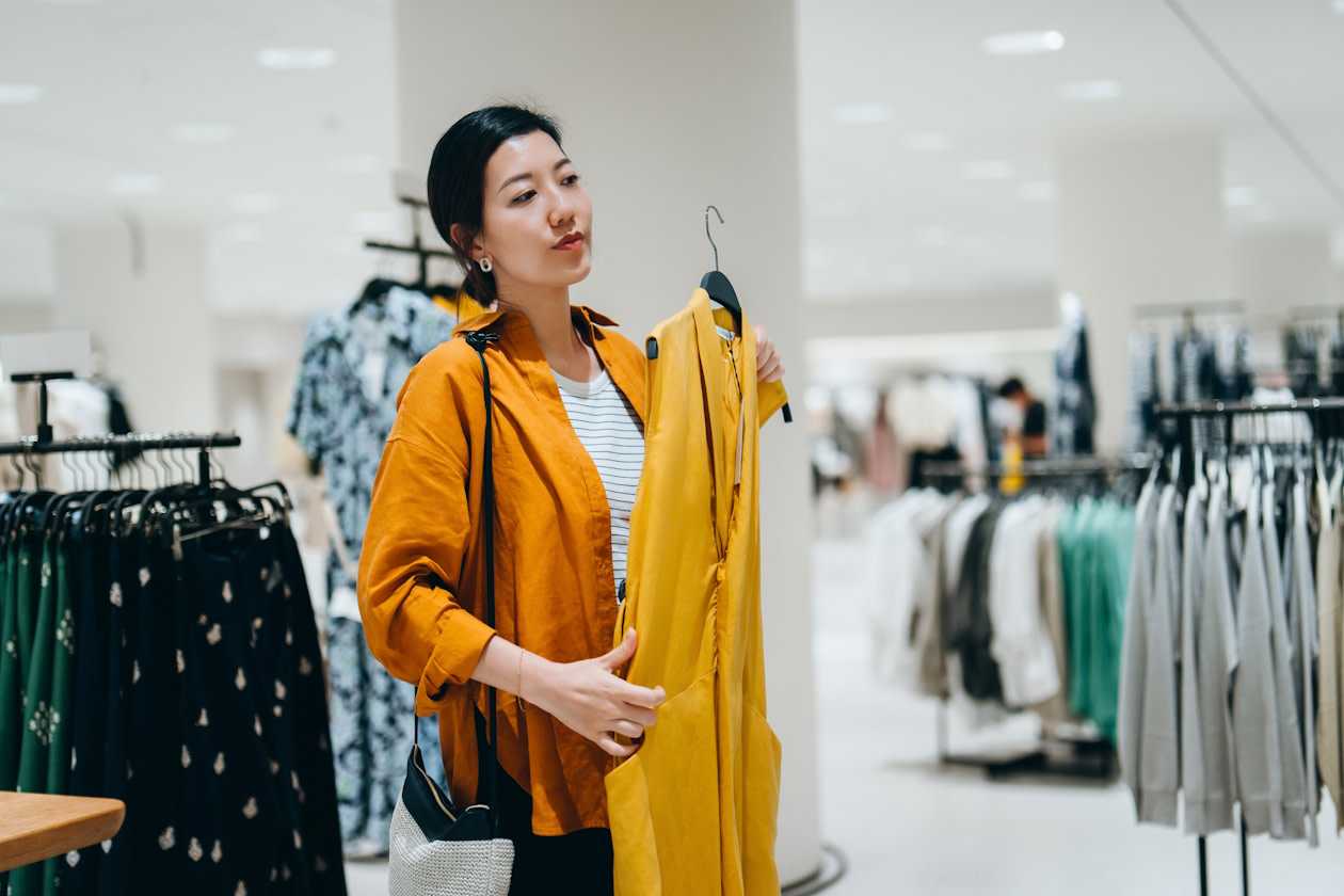 Woman looking at a dress in a clothes shop.jpg
