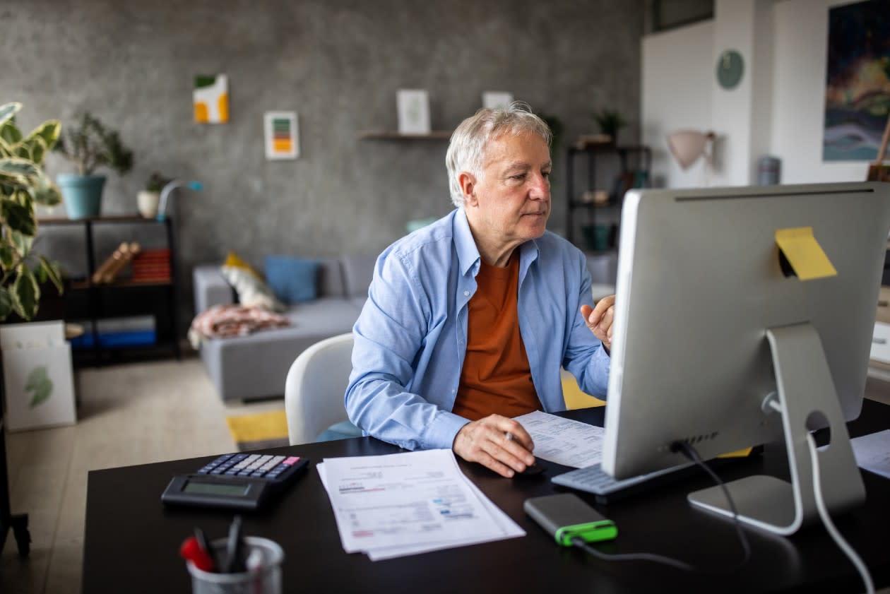 Senior male at computer in a spacious home office.jpg