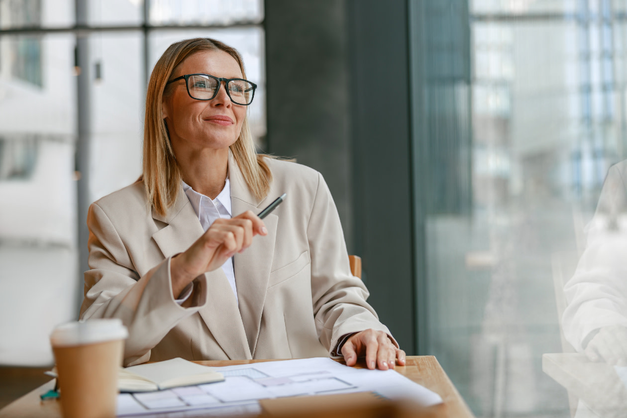 Businesswoman architect in glasses working on project while sitting in cafe.jpg
