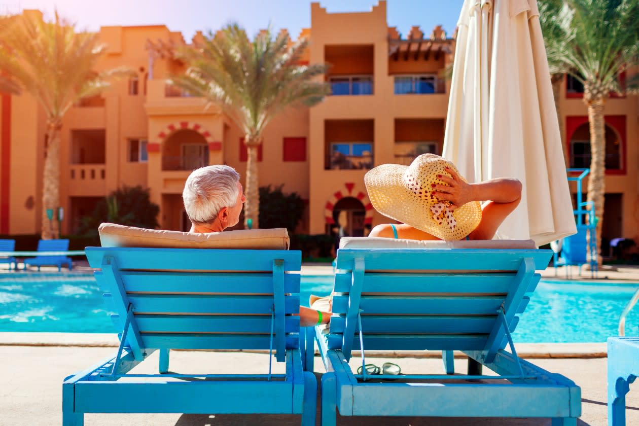 TUI - Older couple relaxing infront of the pool on an all inclusive holiday.jpg