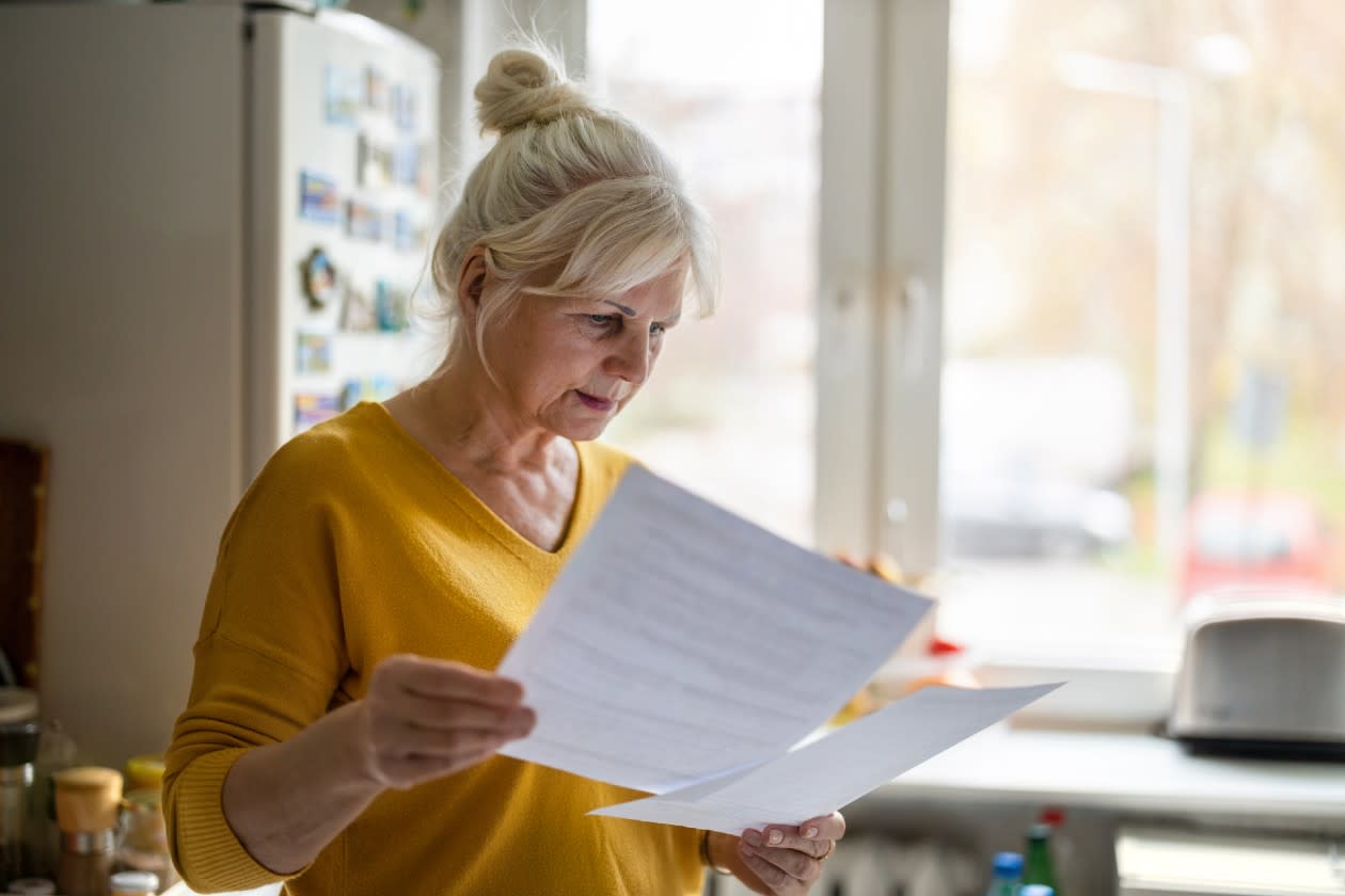 Concerned pensioner checking a tax letter.jpg