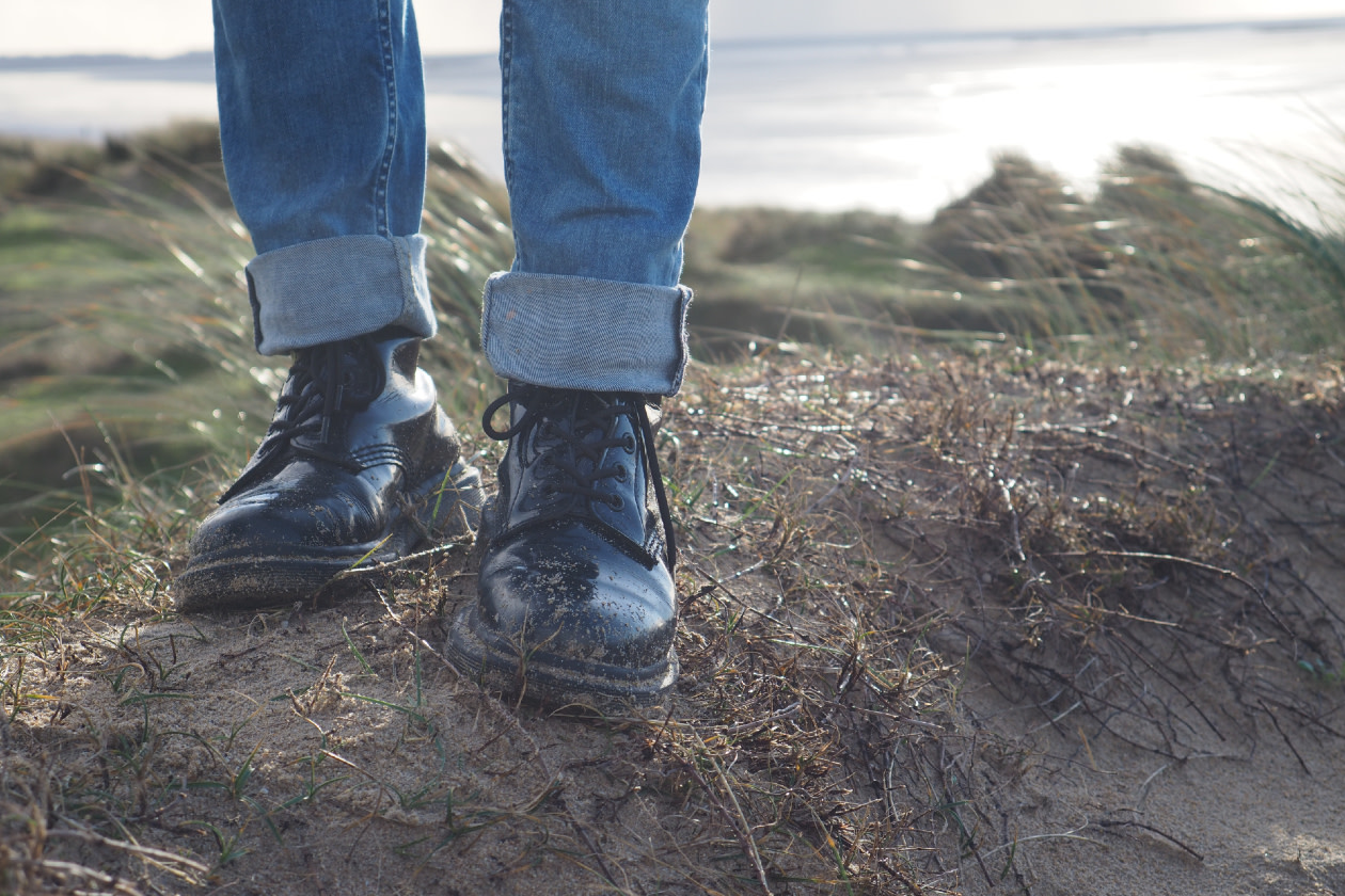 Dr. Martens shoes in the sand and grass