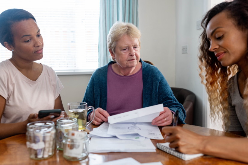 Friends helping an older woman with her finances.jpg