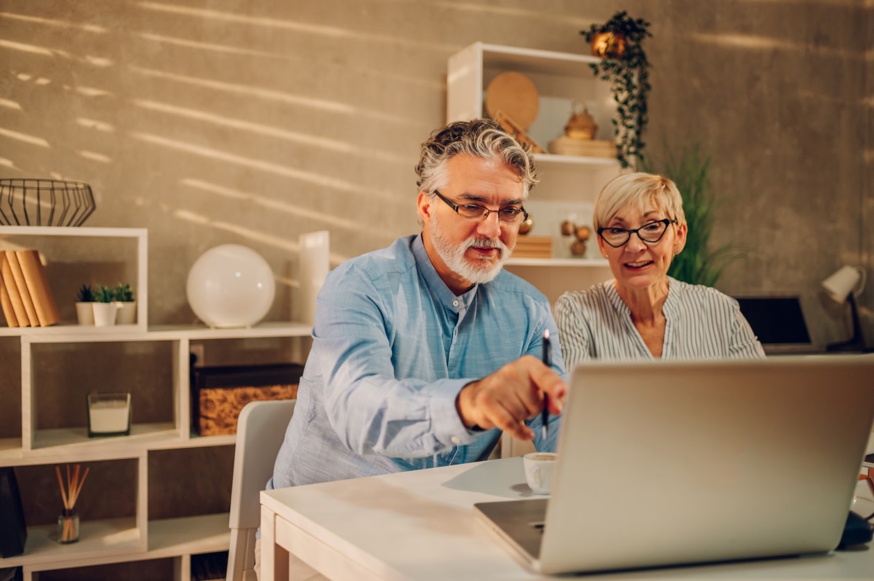 Older couple on the computer smiling