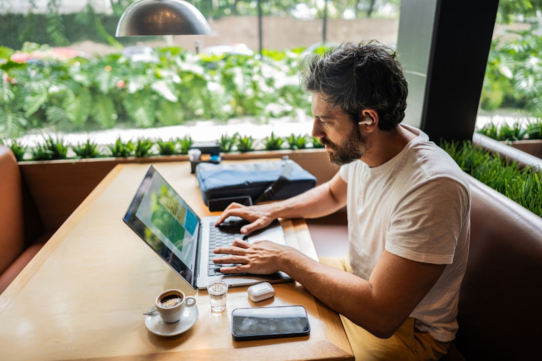 Self employed man working on laptop in a cafe.jpg
