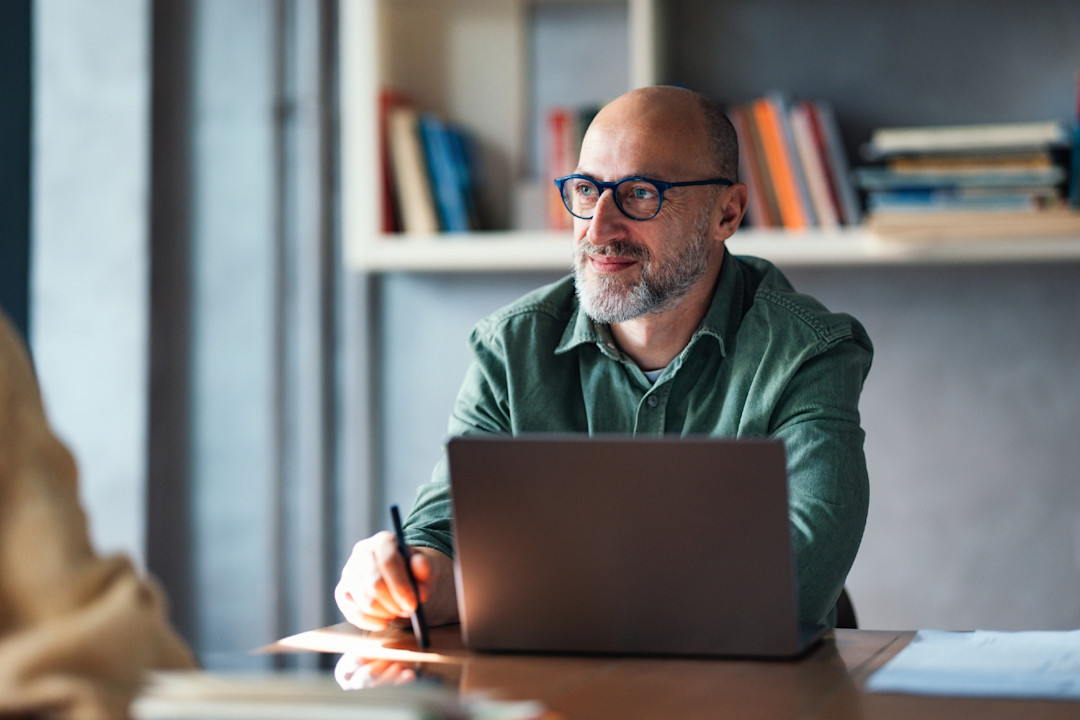 A mature man using his laptop at home.jpg