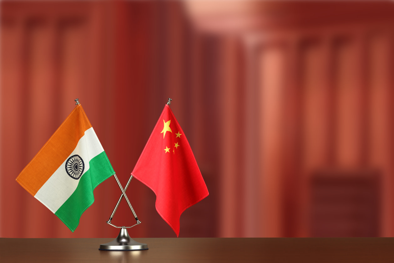 China and India national flags on wooden table.jpg