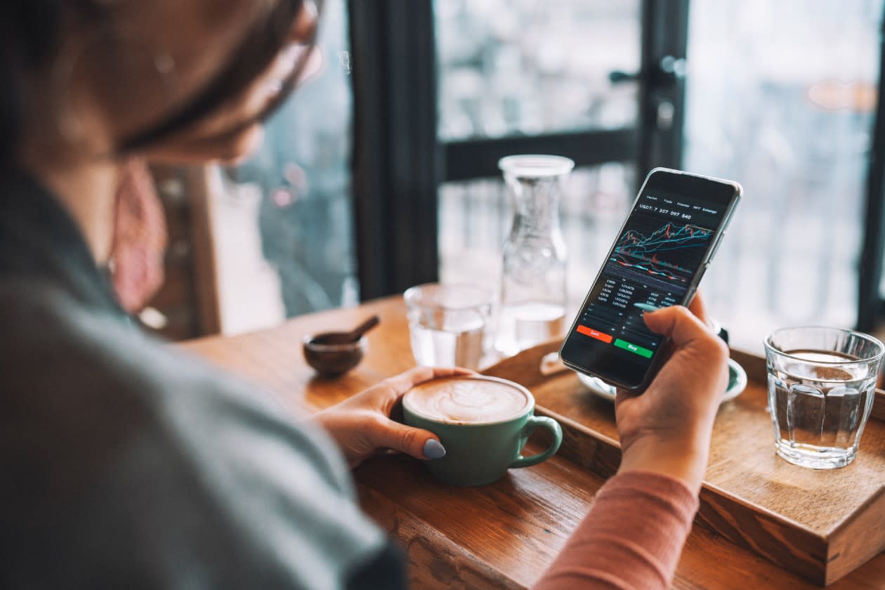 Female investor reviewing performance while out in a coffee shop.jpg