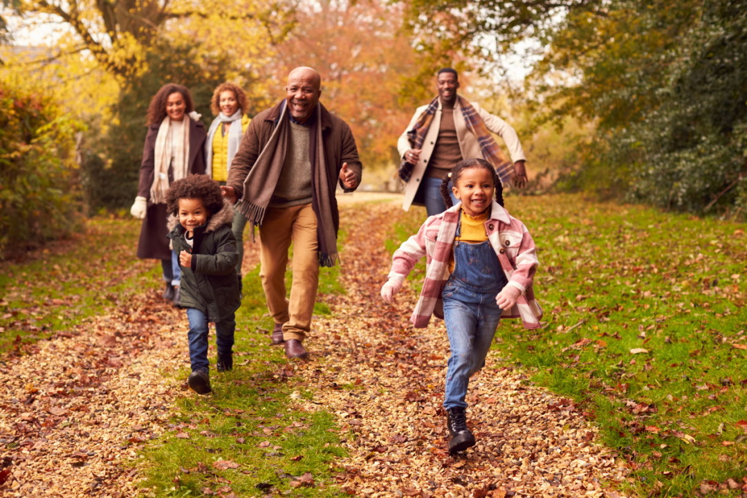 Family enjoying autumn walk in the woods