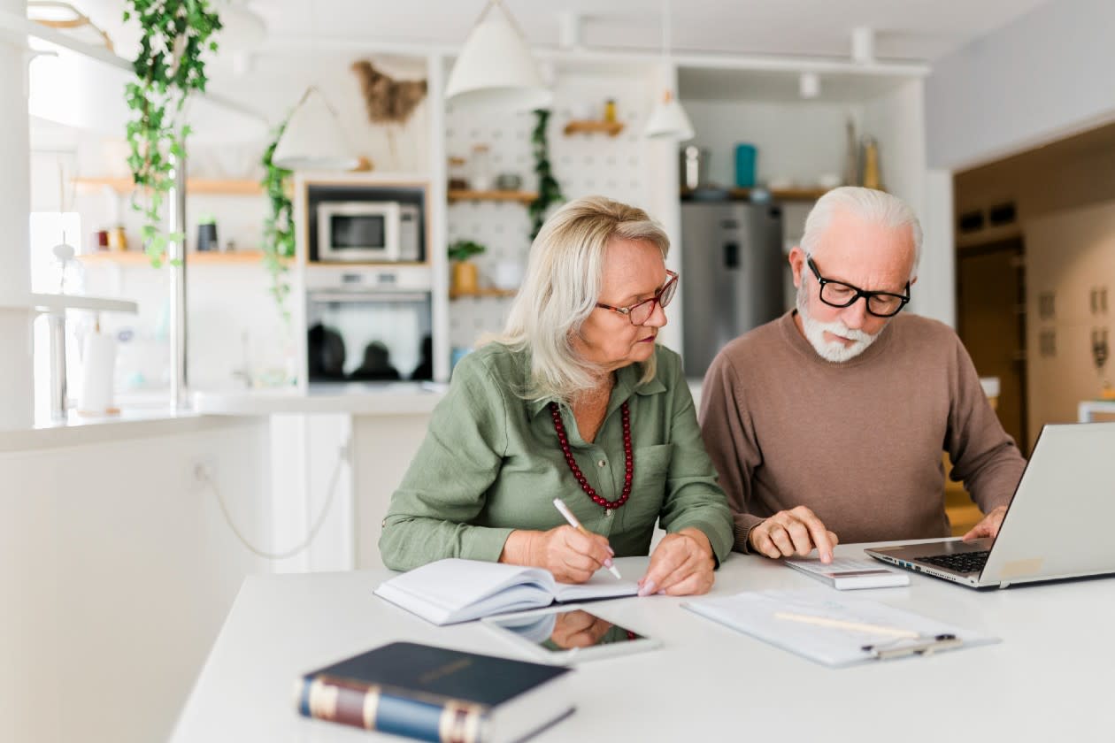 Senior couple reviewing their finances in a spacious kitchen.jpg