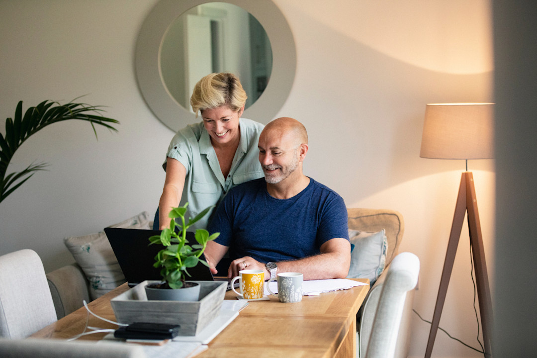 Happy family at their home browsing the web