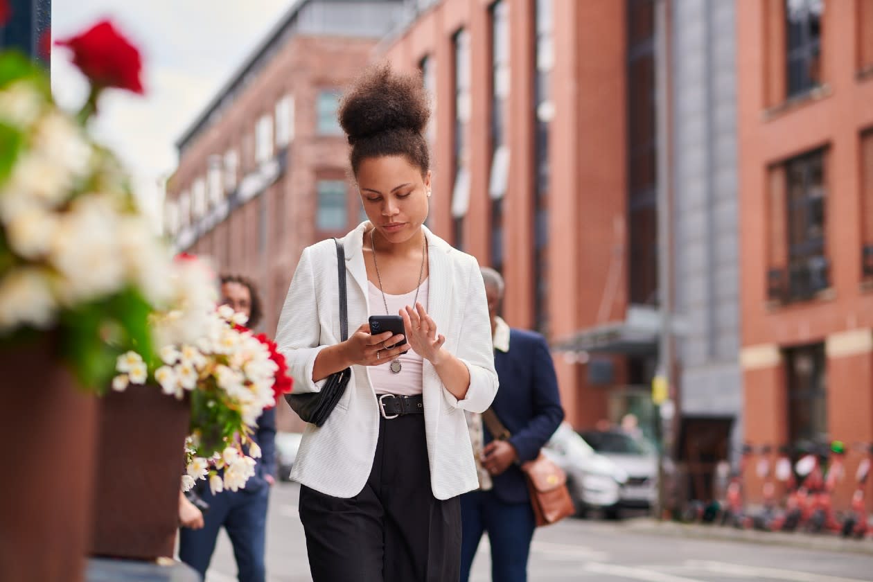 Young female professional reading her phone while commuting to work.jpg