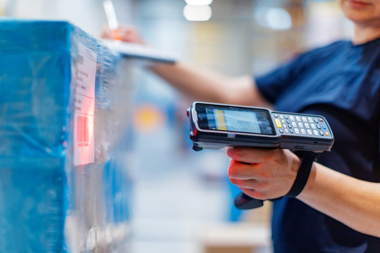 Alibaba - a woman scans an item in a warehouse.jpg