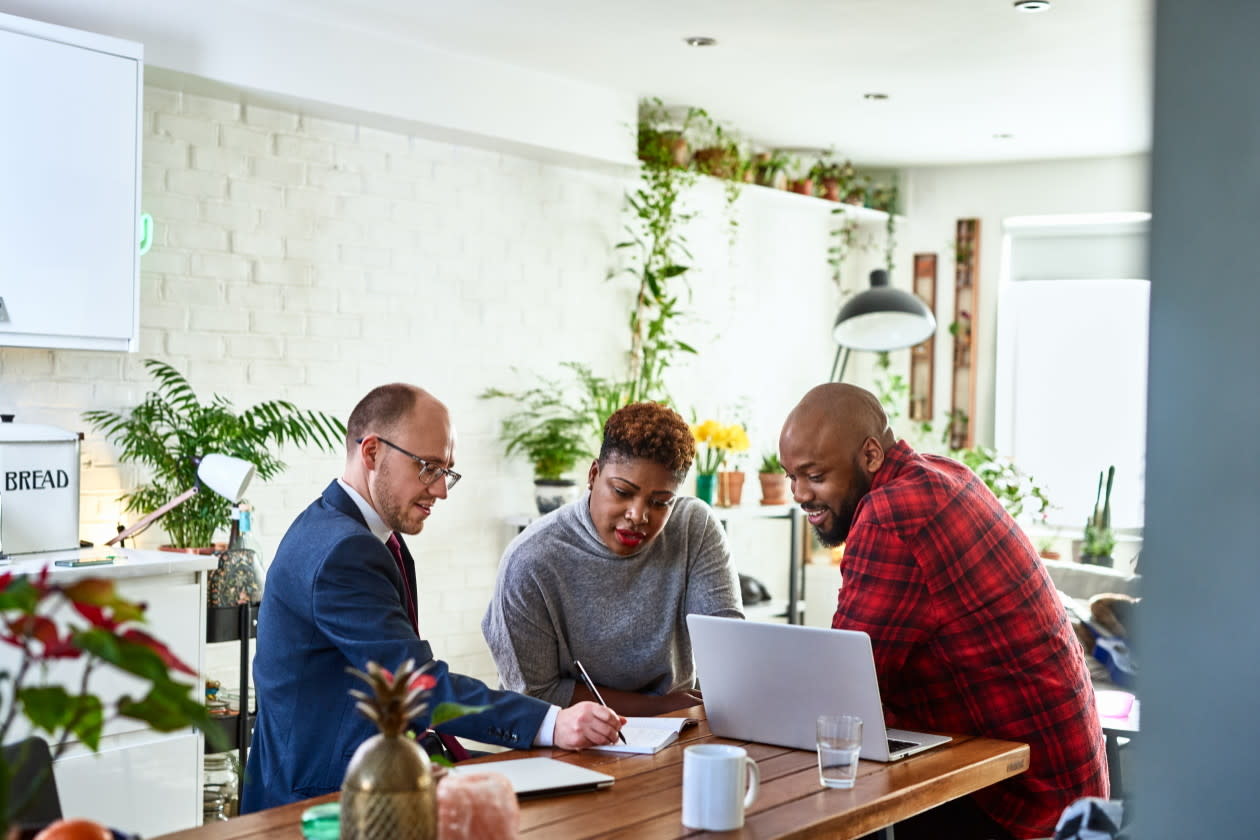 Couple listening to financial advisor at home with laptop.jpg