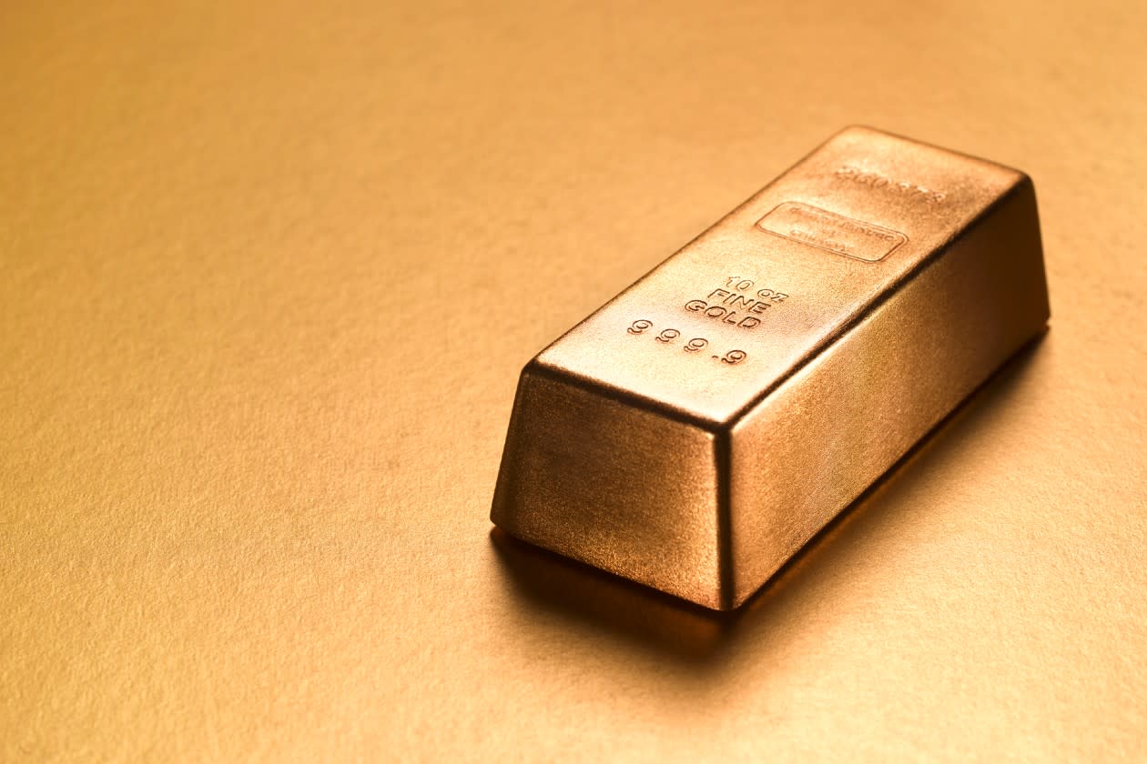 Gold ingot against a gold coloured background.jpg