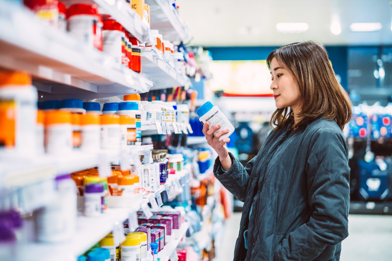 Shopping for multi vitamin & health supplements on shelf in supermarket - GettyImages