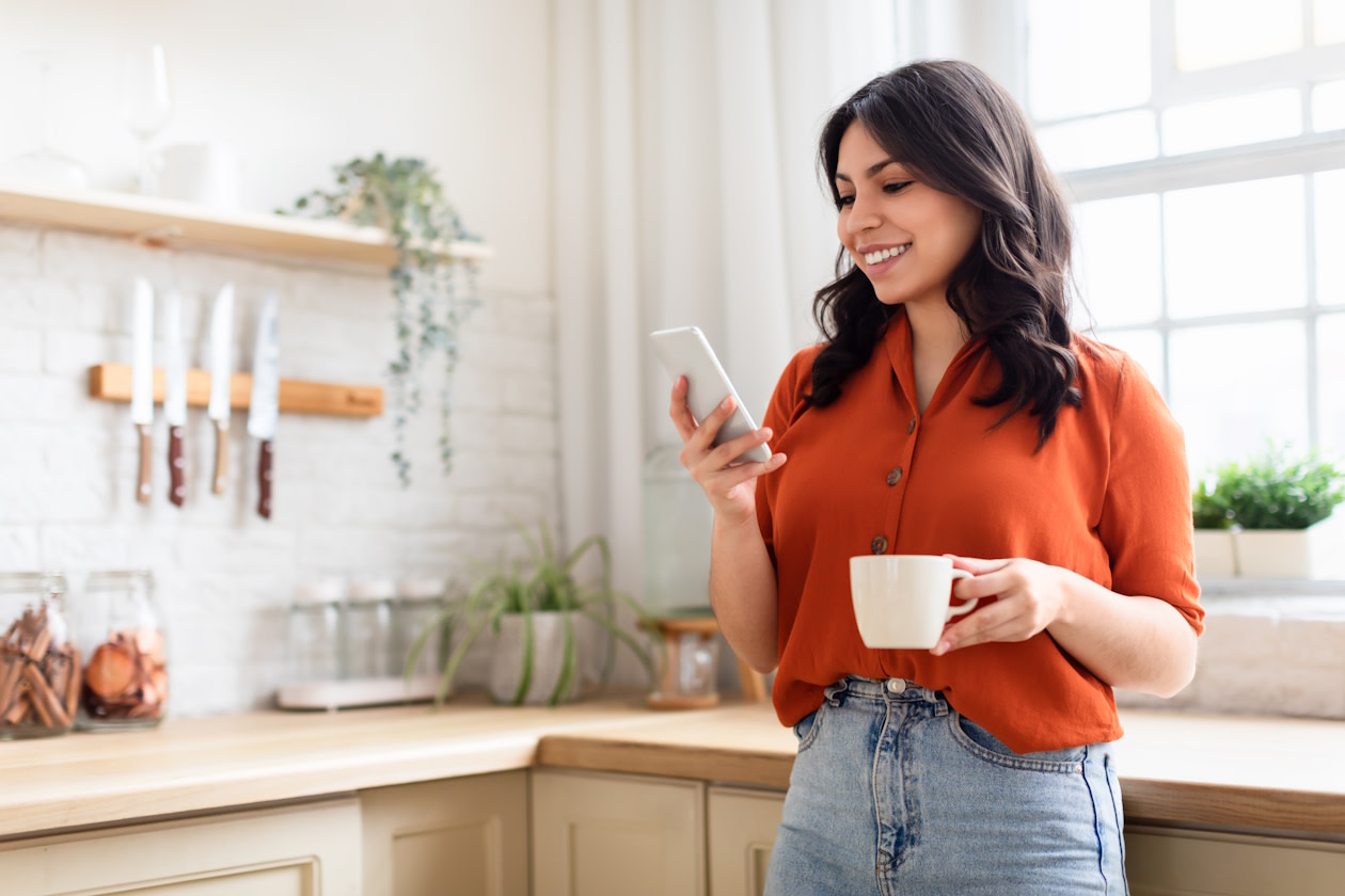 Woman looking at her phone smiling