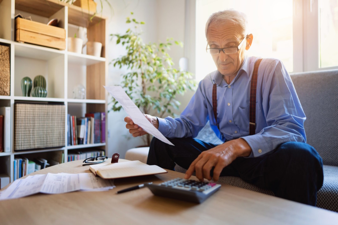 Senior man checking his finances at home