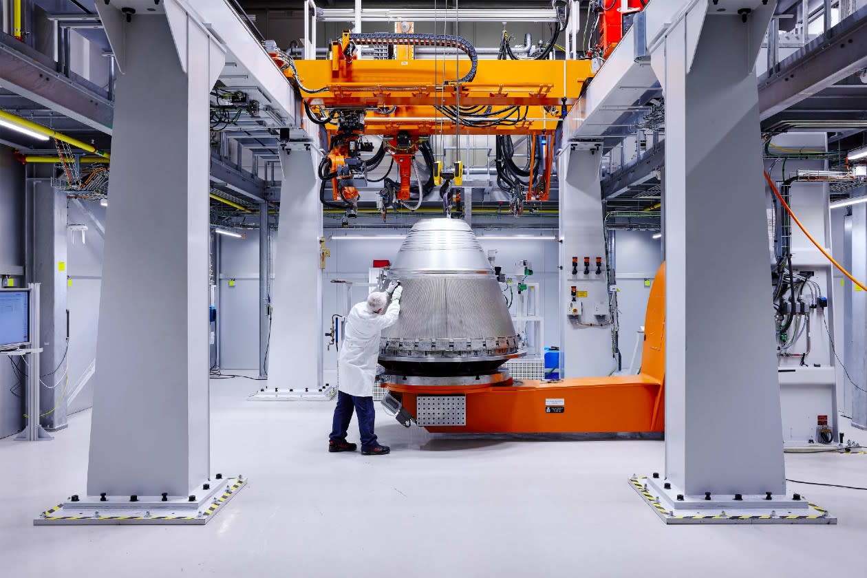 Melrose - an airplane engineer reviewing a component in a factory.jpg