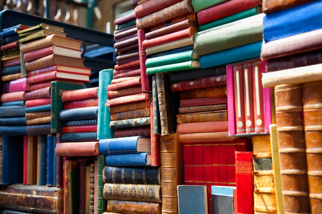 A series of colourful old books stacked next to eachother in a bookshop.jpg