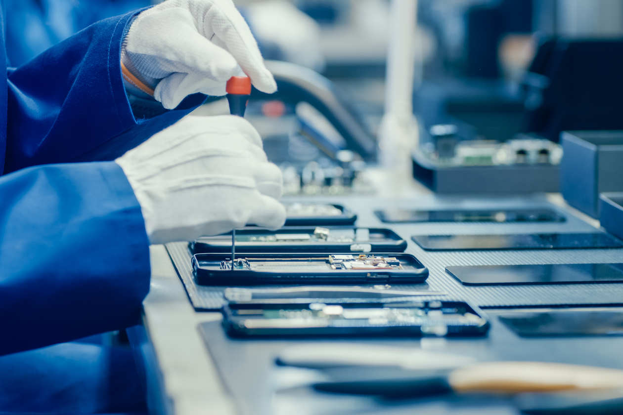 Mobile phones being assembled in a factory.png