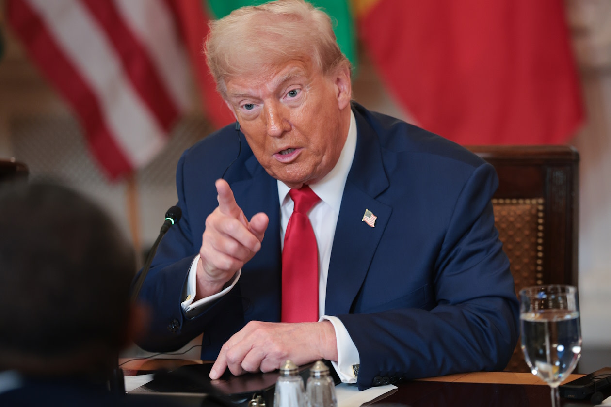 Trump sitting and pointing