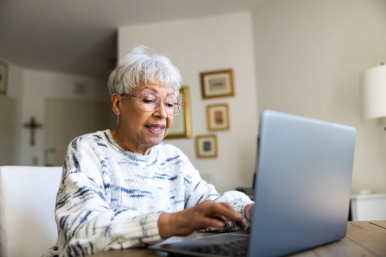 Female pensioner typing on her laptop.jpg