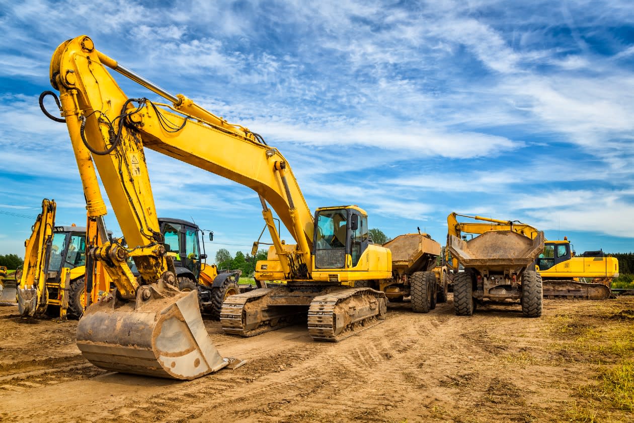 Ashtead - outdoor construction vehicles parked on a dry muddy field.jpg