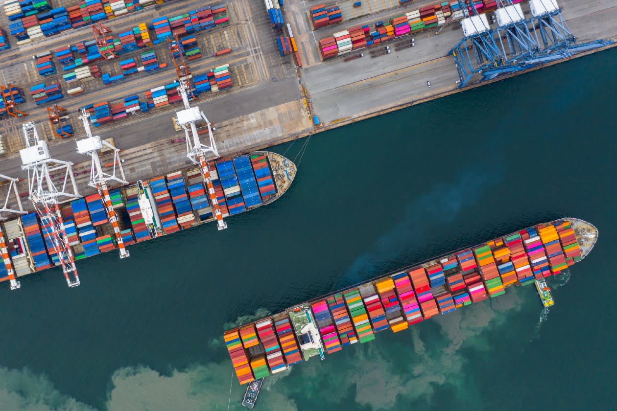 A cargo ship leaving a port.jpg