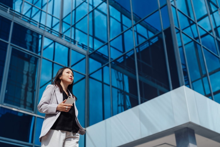 Woman standing outside a glass building.jpg