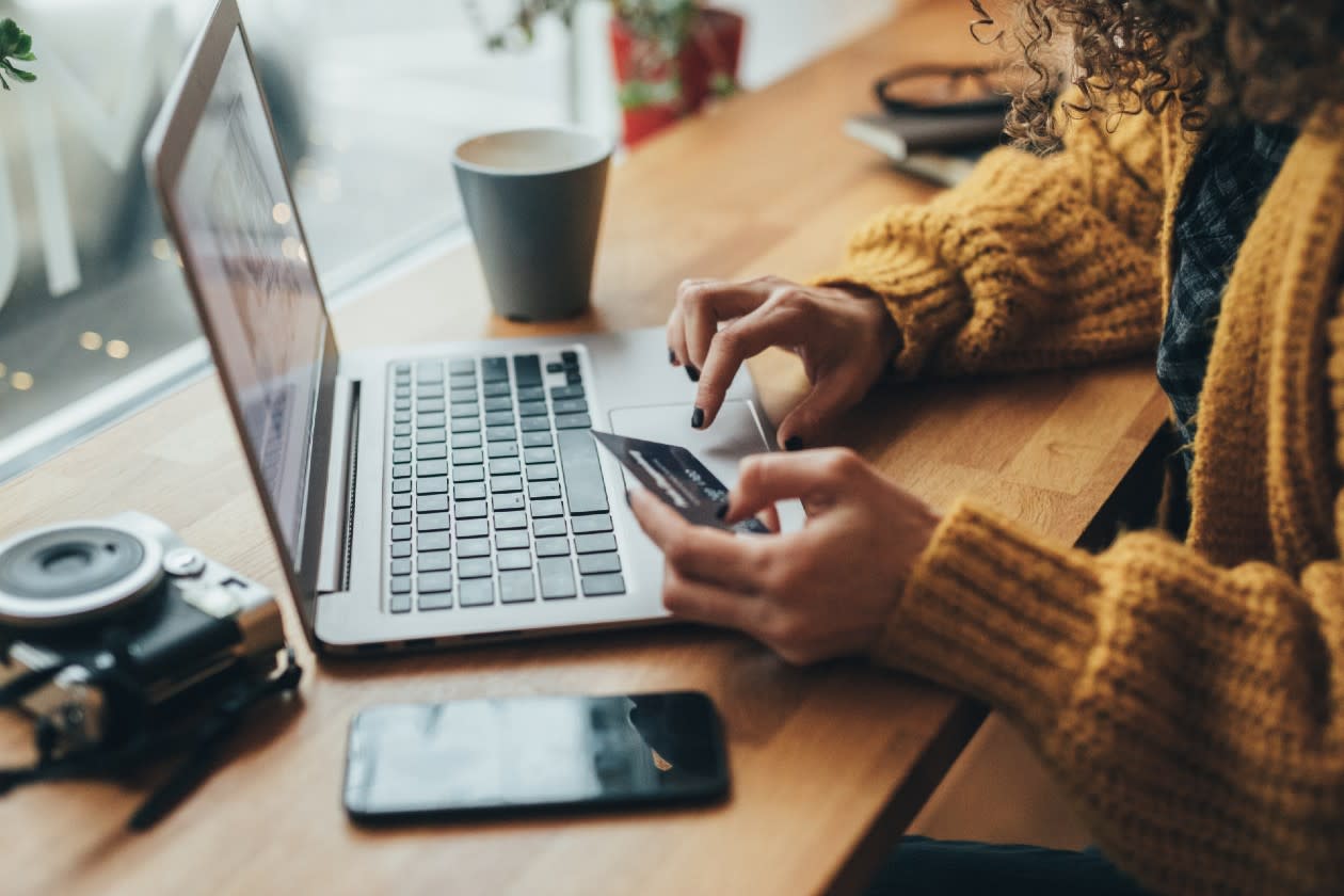 Woman buying things on her laptop in a coffee shop.jpg