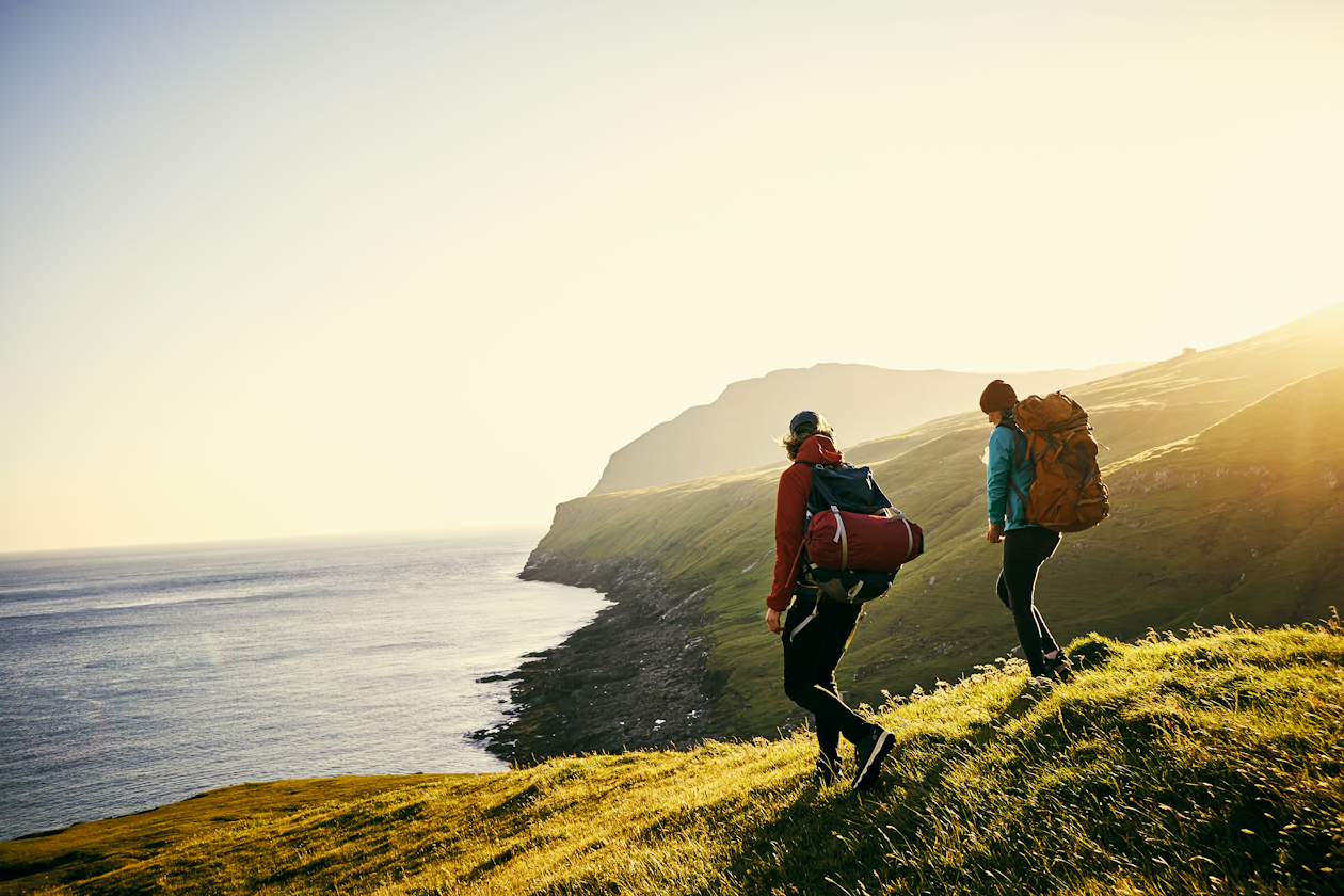 Janus Henderson image - Two people hiking by the coast