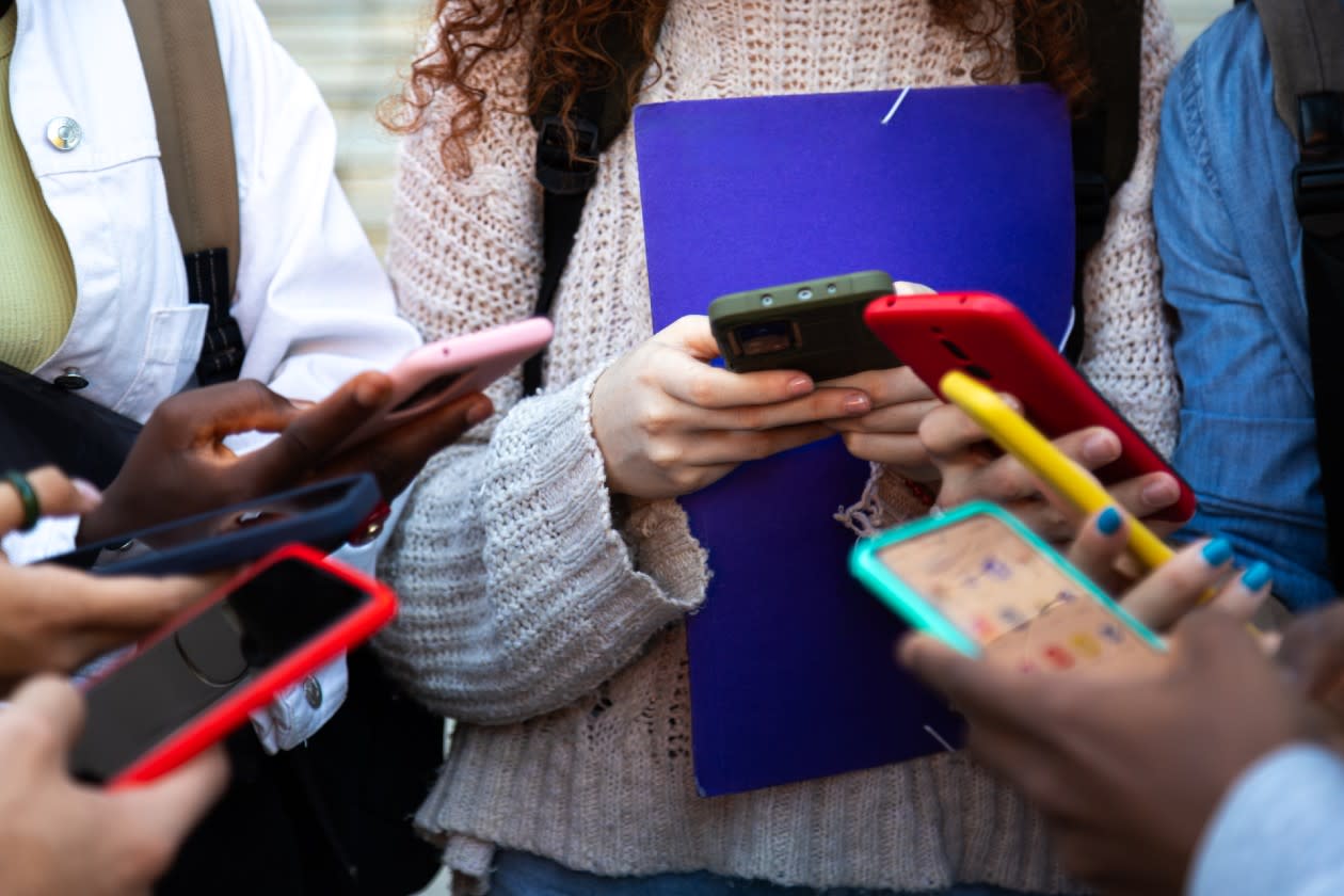 Meta - group of young people in a circle using social media on their phones.jpg