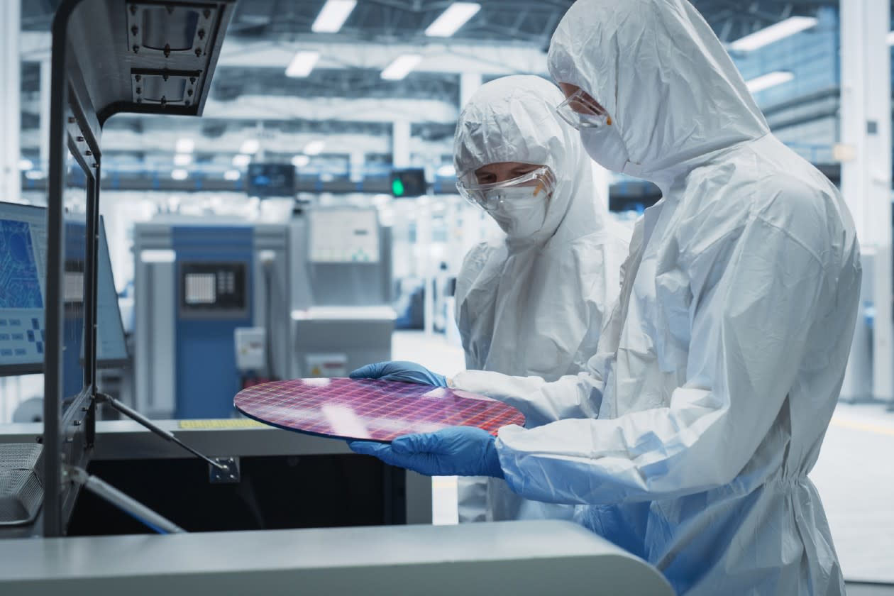 TSMC - technicians inspecting semiconductor components in a factory.jpg