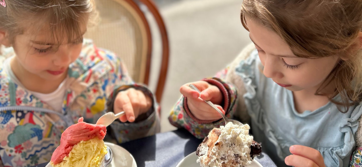 Maike-s children eating ice cream together at a table.jpg