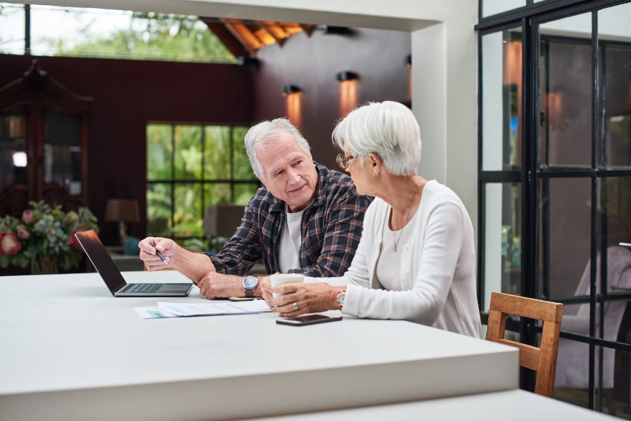 Retired couple discussing finances in their spacious kitchen.jpg