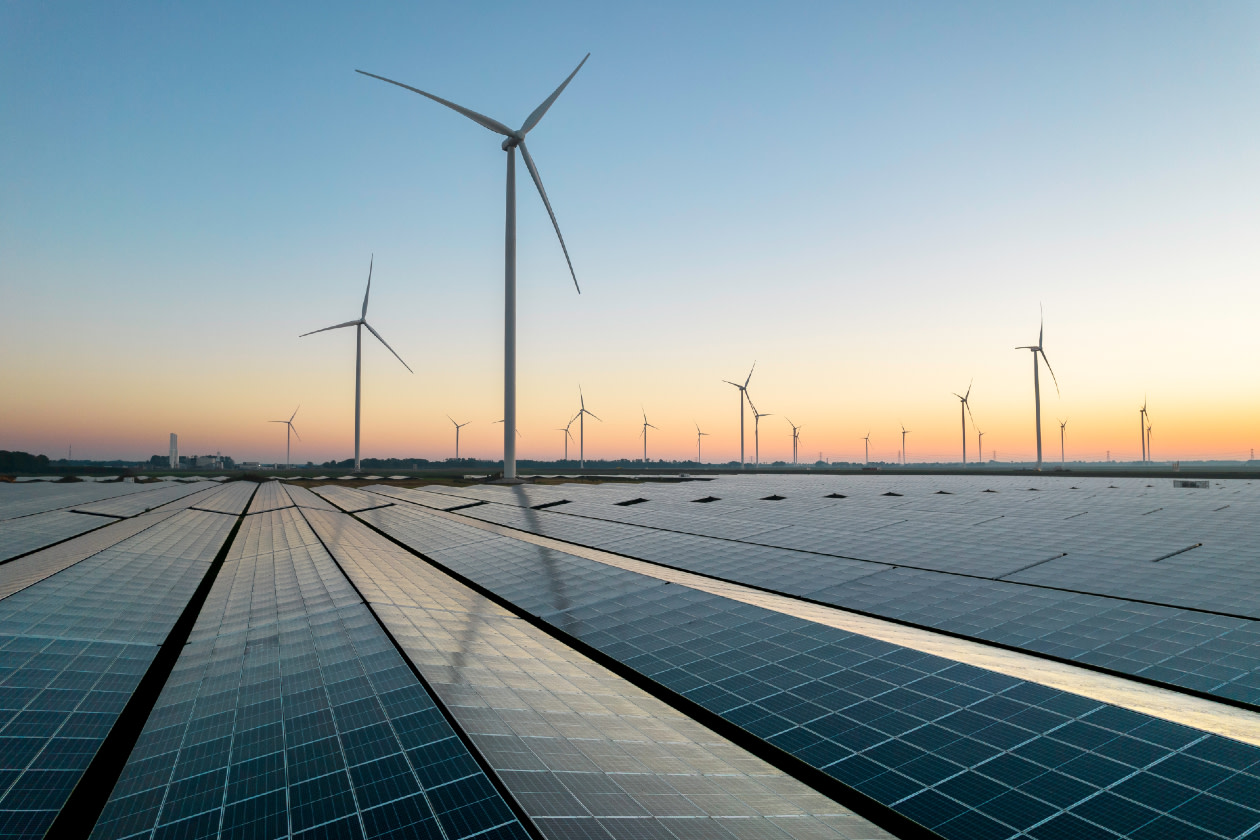 Solar energy field and wind turbines - GettyImages