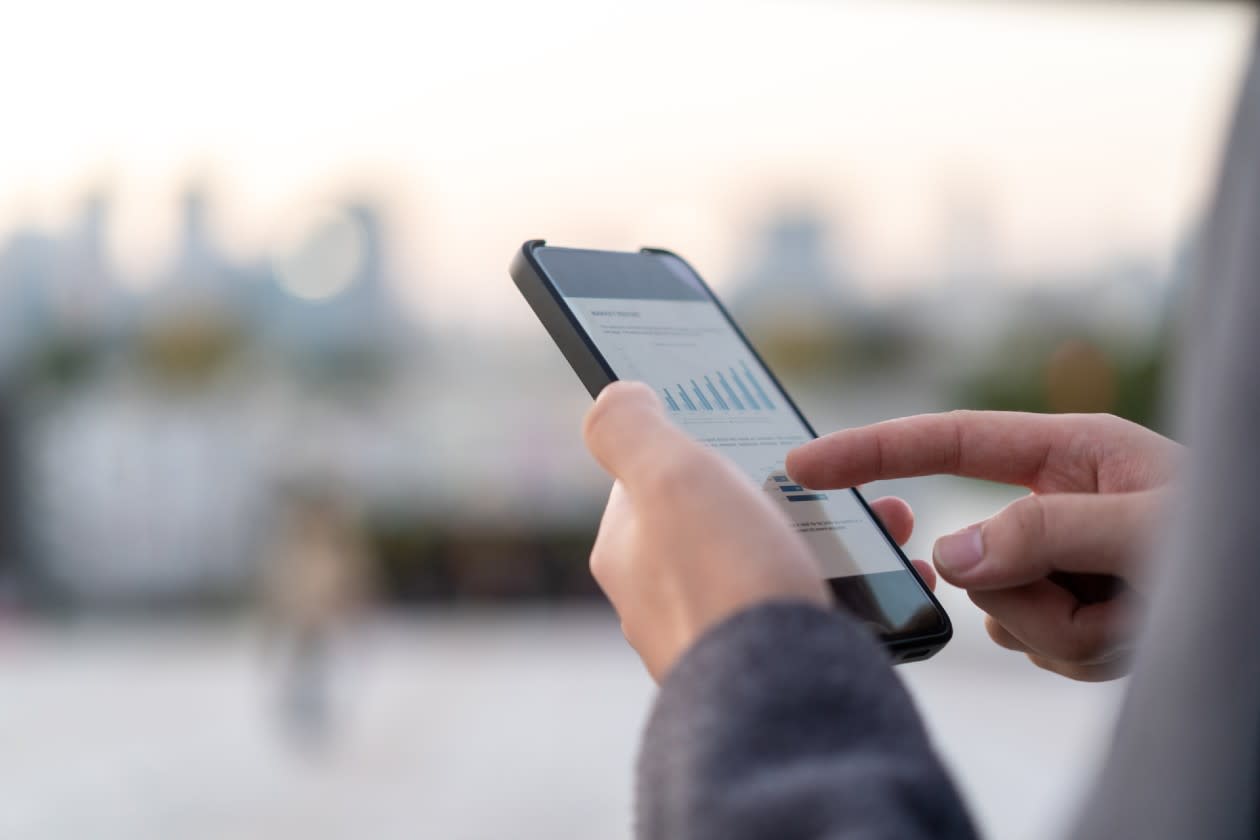 Investor inspecting rising data on a chart on their phone.jpg