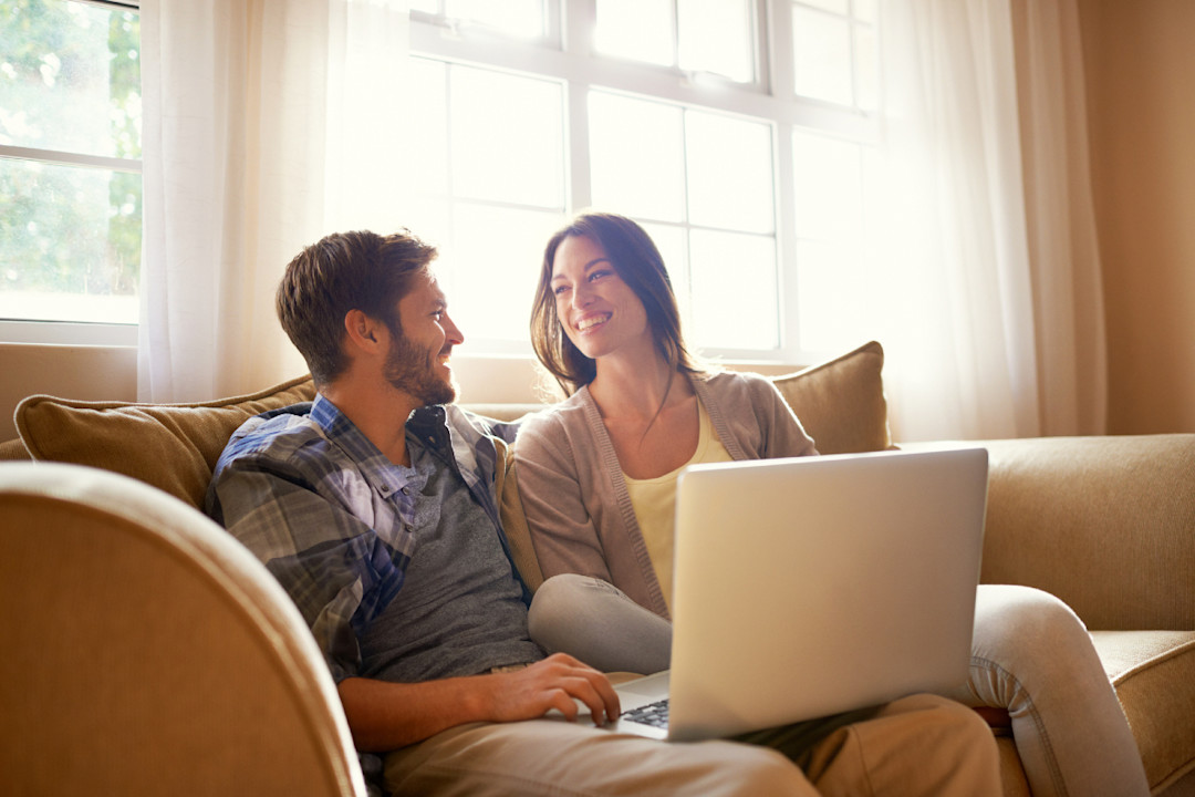 A happy young couple sitting of the sofa.jpg