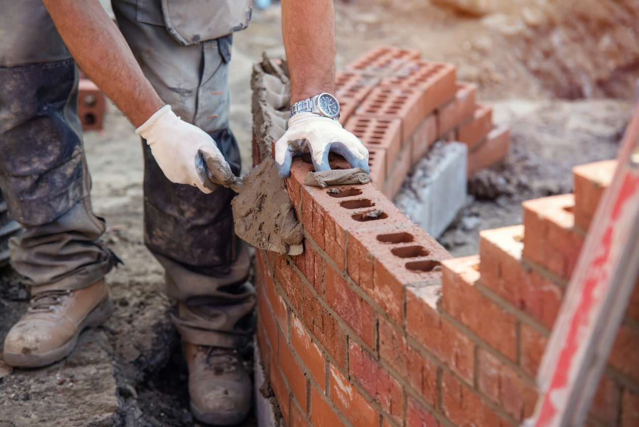 Construction worker laying a brick wall.jpg